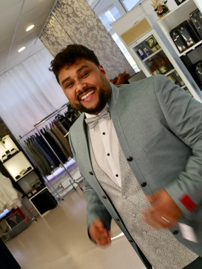 a man in a suit and bow tie