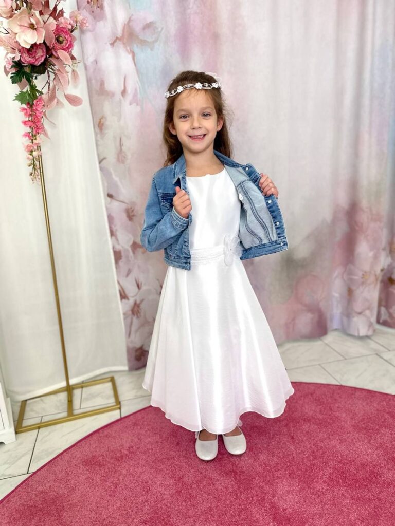 Kommunionkleid mit Jeansjacke – moderner Kommunionlook für Mädchen, stilvoll und kindgerecht, erhältlich bei Bianca’s Brautmoden Bad Münster.